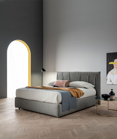 Bed with upholstered headboard and space saving storage box Folder
